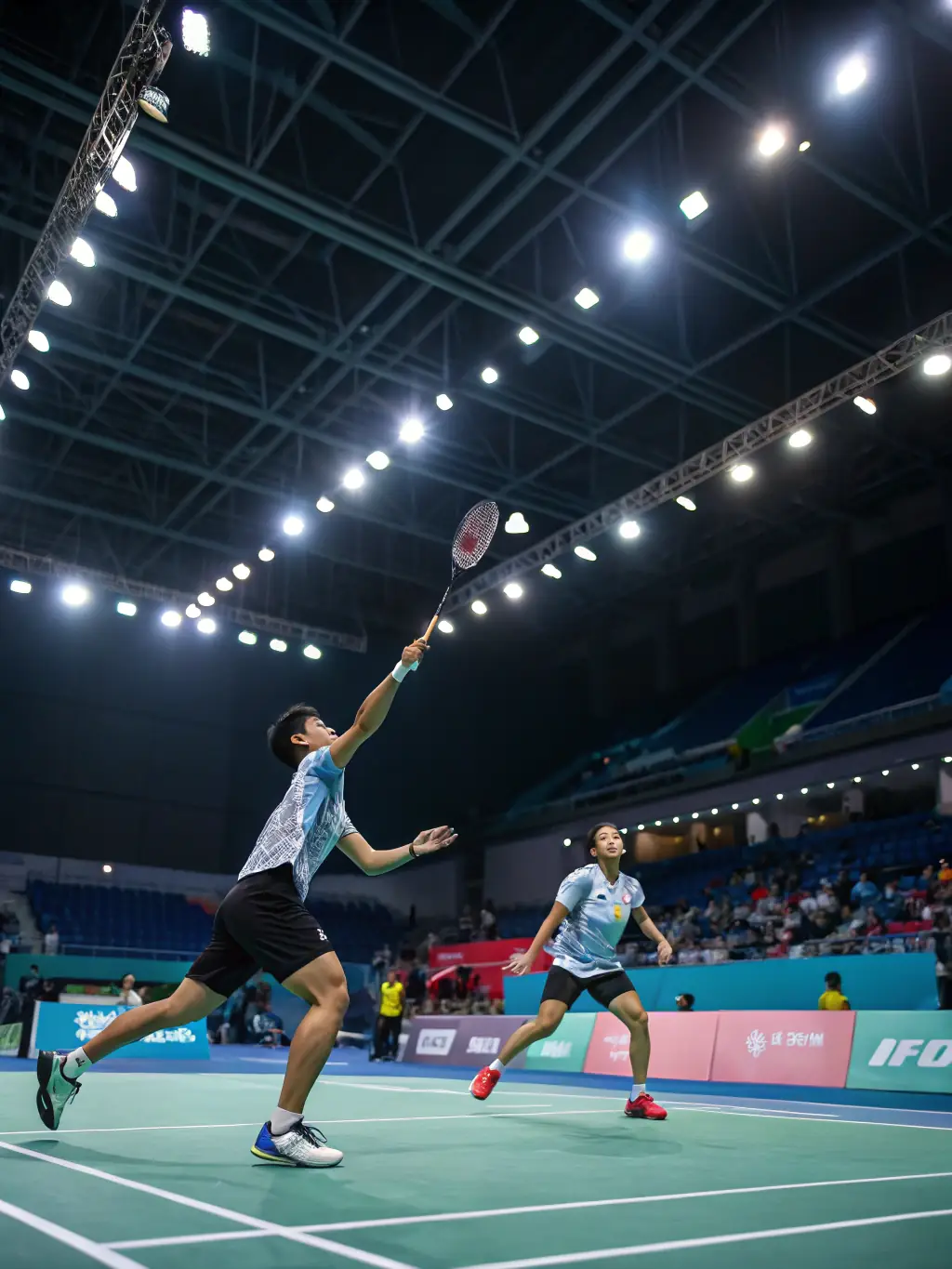 A dynamic shot of badminton players in action during a training session, showcasing skill development and teamwork.